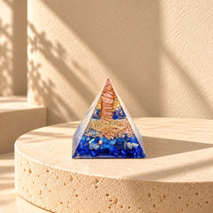 Inner peace orgonite pyramid with rose quartz and lapis lazuli styled for a calm self-care or meditation space