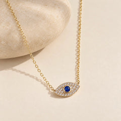 Gold-plated 925 sterling silver evil eye necklace with zircon-set blue eye pendant styled with a smooth warm ivory stone