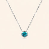 Front view of blue zircon necklace in 925 sterling silver, featuring a faceted blue-green round stone in a polished bezel setting on a delicate silver chain