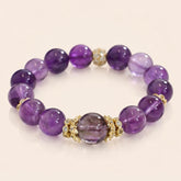 Uruguayan Amethyst Quartz bracelet with gold accents on background, set against a light cream background.
