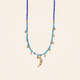 Crescent moon charm necklace with gold-tone chain and turquoise stones