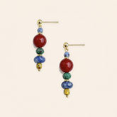 red agate and sodalite handmade earrings with copper ear pins on a light beige background.