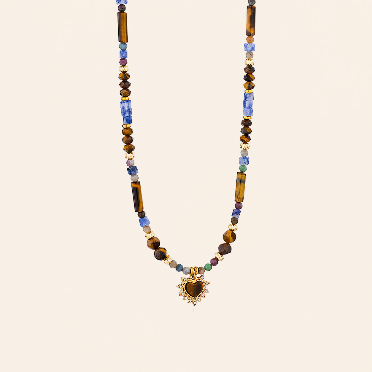 Tiger’s Eye and Sodalite heart necklace with blue and brown natural stone beads on a cream background