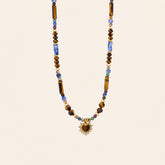 Tiger’s Eye and Sodalite heart necklace with blue and brown natural stone beads on a cream background
