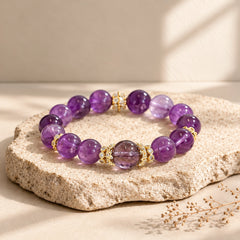 Uruguayan amethyst crystal bracelet styled as jewelry, showing polished violet beads and decorative gold-tone details