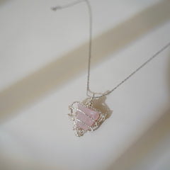 Romantic pink crystal pendant on minimal background