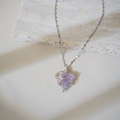 Heart-shaped purple crystal pendant for chakra healing