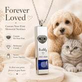 Personalized pet nose print urn necklace with blue birthstone crystal, custom name and memorial date beside a dog and cat