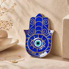 Blue Hamsa Evil Eye Ceramic Trinket Dish displayed as spiritual protection decor on a neutral shelf.