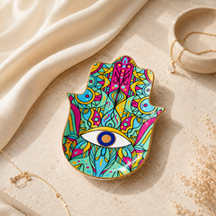 Colorful Hamsa Evil Eye Ceramic Trinket Dish styled as a jewelry dish with gold rings, necklace, and spiritual protection decor.