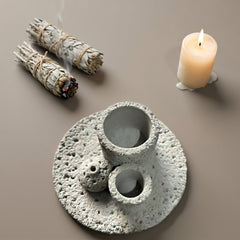 Modern concrete smudge bowl and Palo Santo holder styled with sage bundles and candle