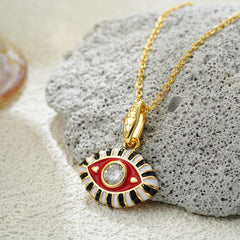 Protective evil eye jewelry in vibrant enamel colors laid flat for product showcase