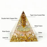 Orgonite pyramid with Tiger’s Eye pillar, Citrine, Rose Quartz and gold foil designed for abundance and wealth manifestation symbolism.