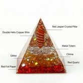 Handmade orgonite pyramid with Red Jasper, Citrine, and Red Quartz for wealth and energy protection.