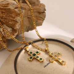 Gold necklaces with cross pendants on a textured surface