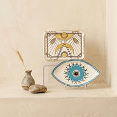 blue evil eye ceramic tray with radiant motif displayed as spiritual home decor