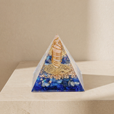 Orgonite pyramid with rose quartz point, blue lapis lazuli stones, copper coil and gold details for emotional healing and inner peace