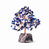 lapis lazuli feng shui crystal tree with natural amethyst base on a white background