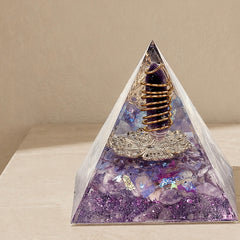 Close-up of a family harmony orgonite pyramid with amethyst point, lavender fragments and copper coil details