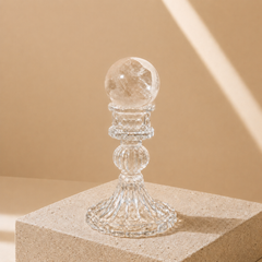 Natural Clear Quartz Crystal Sphere on transparent glass stand for clarity, energy cleansing, and meditation decor