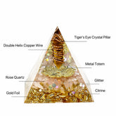 Orgonite pyramid featuring Tiger’s Eye, Citrine, Rose Quartz, copper wire, gold foil and symbolic metal details.