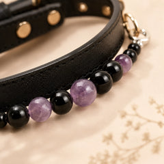 Close-up of purple amethyst and black obsidian beads on dog collar