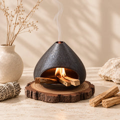 Fired Earth Brown ceramic sage and Palo Santo burner with sage bundle and wood sticks in a neutral home