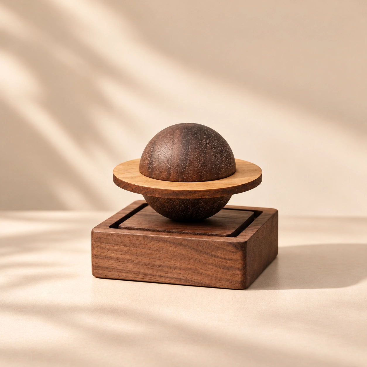 Saturn wooden essential oil diffuser with natural wood grain and orbiting ring on a warm neutral display