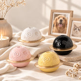 Planet-shaped ceramic pet urns for ashes in white, pink, yellow and black with gold rings