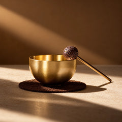 Solid brass mini singing bowl with lava stone striker shown as a compact mindful sound ritual set