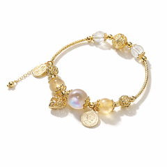 Citrine, Moonstone & Clear Quartz Bracelet with various beads and charms on a white background