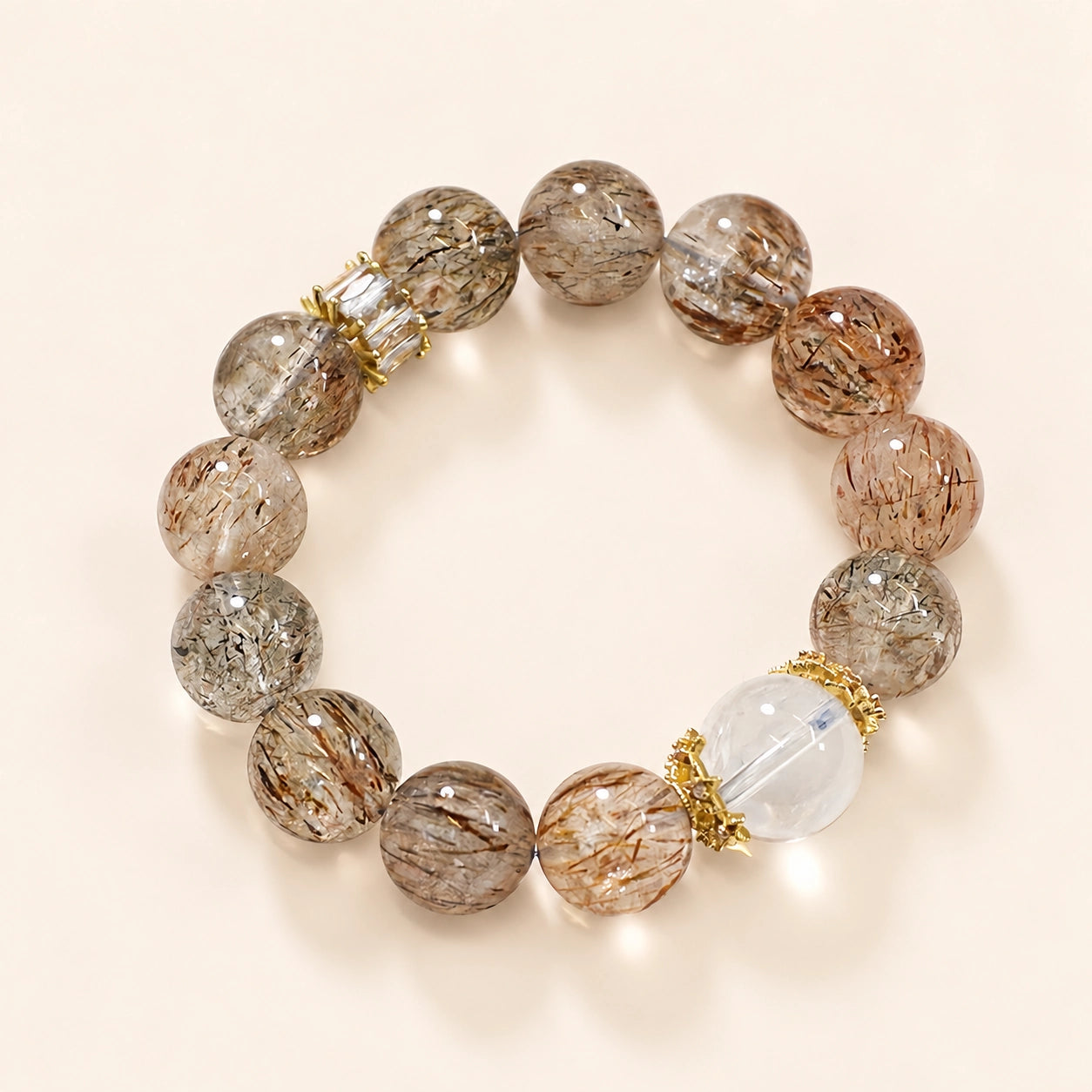Black Golden Super Seven bracelet with translucent golden-brown beads, a clear quartz centerpiece and gold-plated accents.
