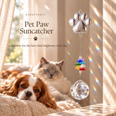 Pet paw crystal suncatcher with round crystal hanging by a sunny window with rainbow reflections, cat and dog nearby