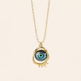 gold evil eye pendant necklace with classic blue eye design on neutral background