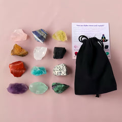 12-piece raw chakra crystal set displayed with guide card and black pouch