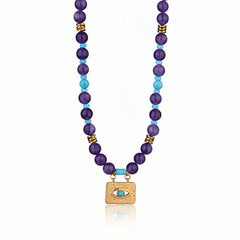 Close-up of an Evil Eye Amethyst & Turquoise Necklace with a gold-plated pendant.