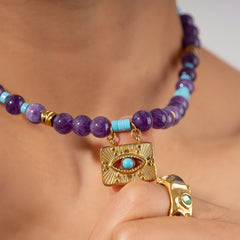 Boho-style beaded necklace with an evil eye charm for energy balance and protection.