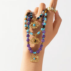 Close-up of an Evil Eye Amethyst & Turquoise Necklace with a gold-plated pendant.