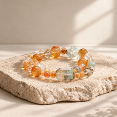 Citrine and Aquamarine multi-crystal stretch bracelet in a warm ivory editorial studio setting