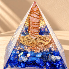 Close-up of rose quartz, lapis lazuli, opal, copper coil and blue foil inside an orgonite pyramid