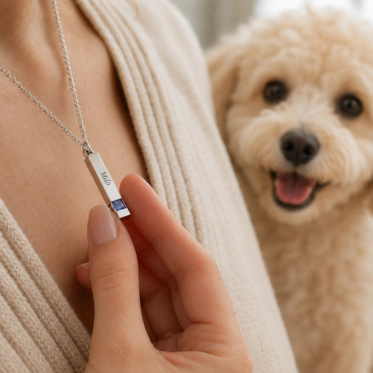 Personalized pet name and birthstone necklace worn close to the heart beside a happy dog