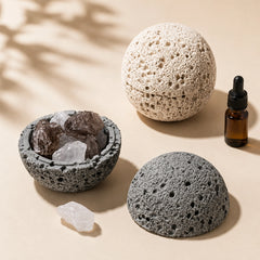 Grey crystal cleansing bowl with quartz beside a closed beige volcanic-texture aroma bowl