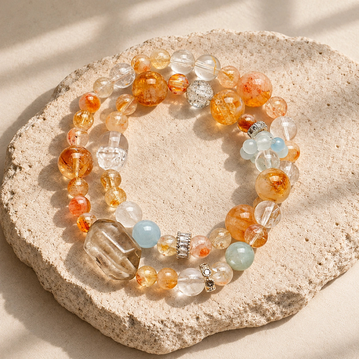 Top-down view of Citrine and Aquamarine crystal bracelet on a minimal warm neutral background