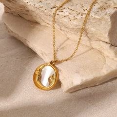 Moon and Star shell necklace with gold-tone crescent pendant in a flat lay