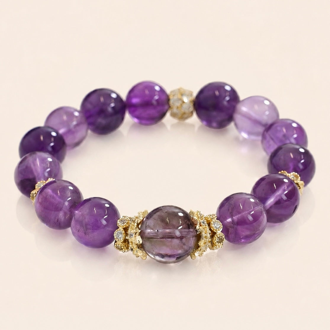 Uruguayan Amethyst bracelet with deep purple crystal beads and gold-tone accents on a cream background