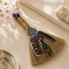 Close-up of handmade Amethyst Peacock Feather Witch Broom with crystal accents and peacock feather altar styling.