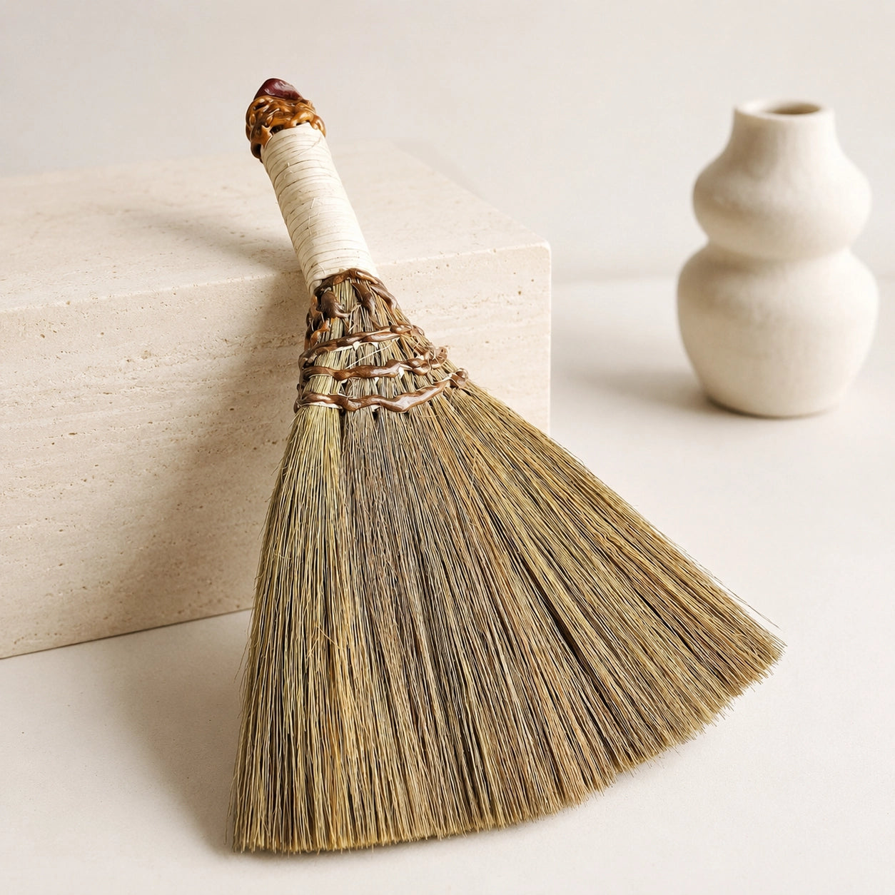 Back view of handmade witch broom with natural straw bristles, wrapped handle, and handcrafted rustic texture.
