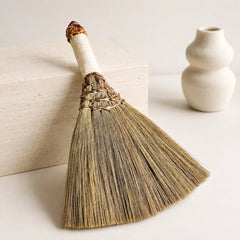 Back view of handmade witch broom with natural straw bristles, wrapped handle, and handcrafted rustic texture.