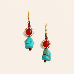 red agate and turquoise handmade earrings with copper hooks on a light cream background.