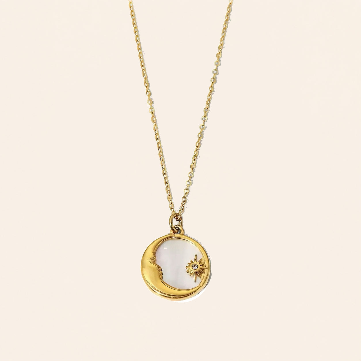 Sun and Moon shell necklace with gold-tone celestial pendant and natural shell inlay